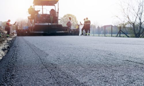 workers-placing-new-coating-asphalt-road